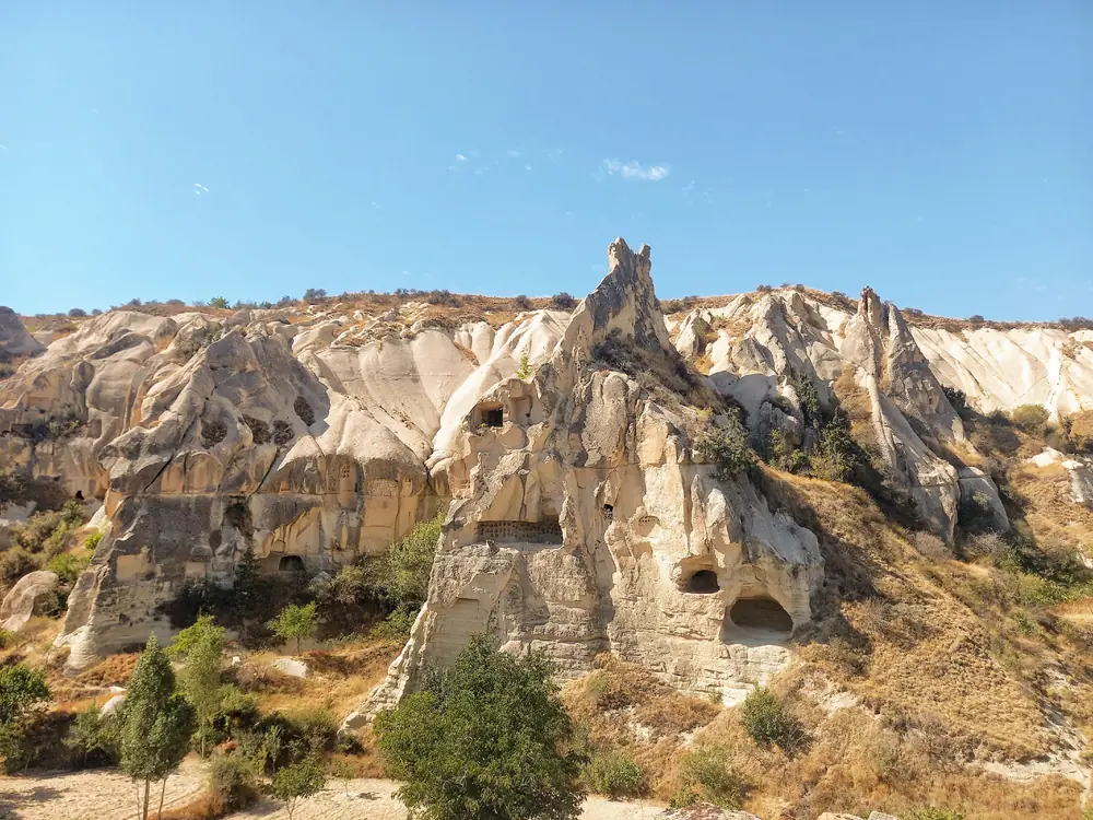 Rooms carved into a pale tuff cliff