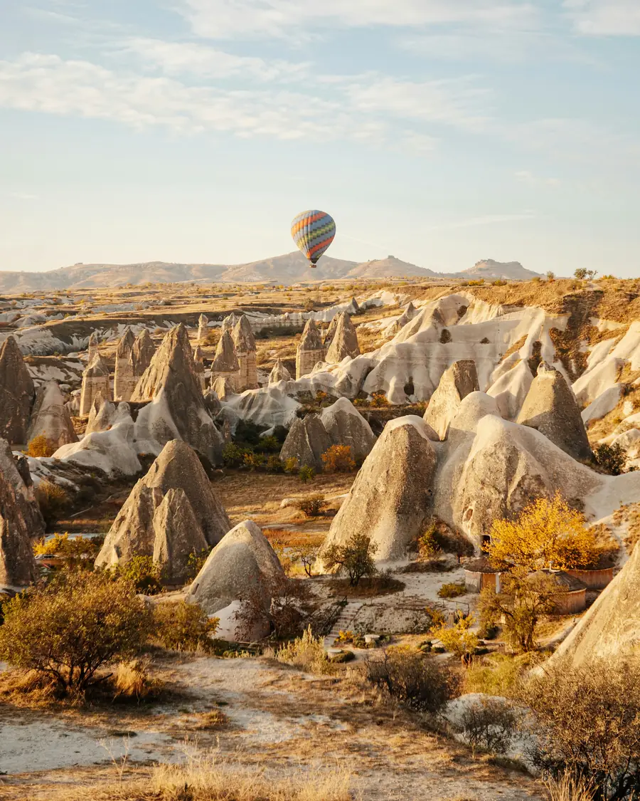 A balloon over the fairy chimneys of Göreme in morning light